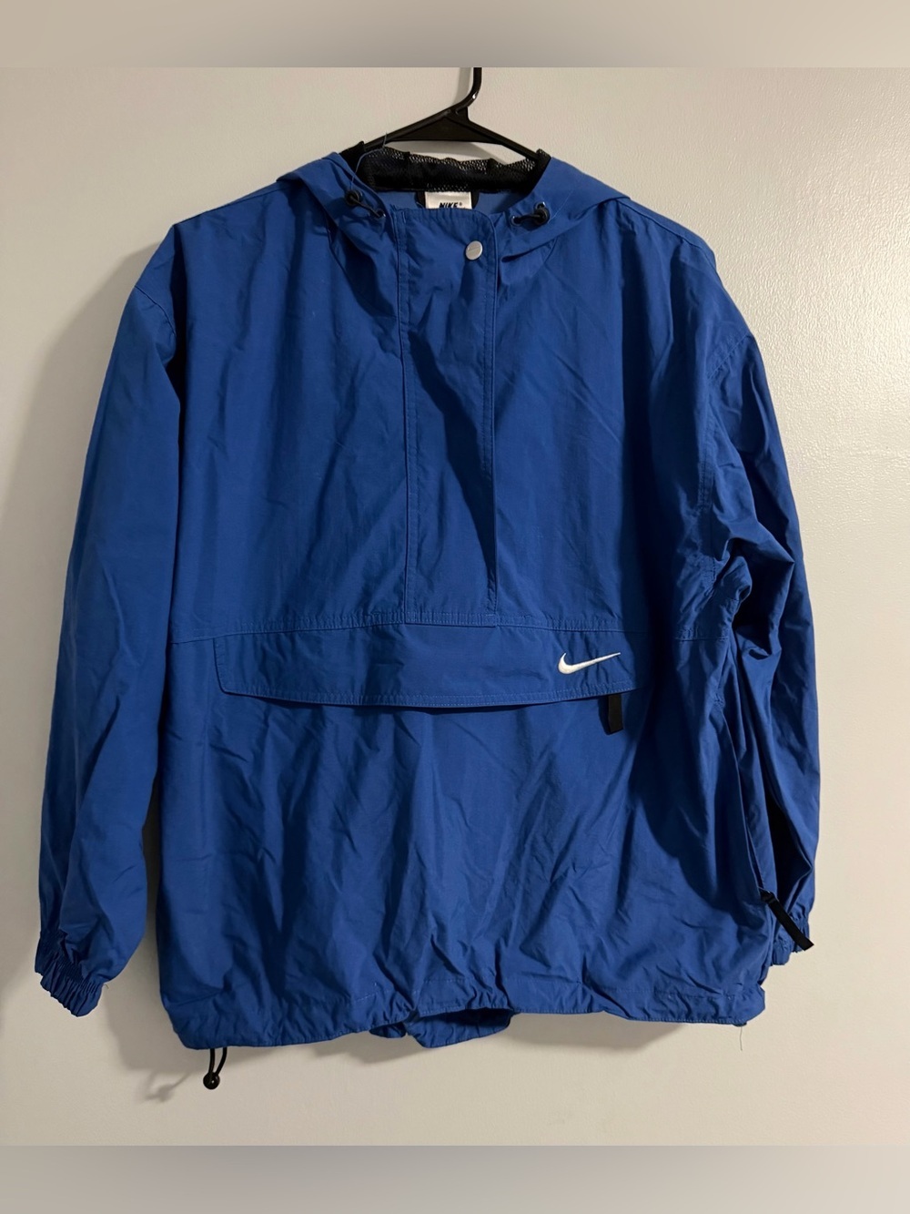 Nike Red Swoosh on White Brand Tag with Blue Fabric